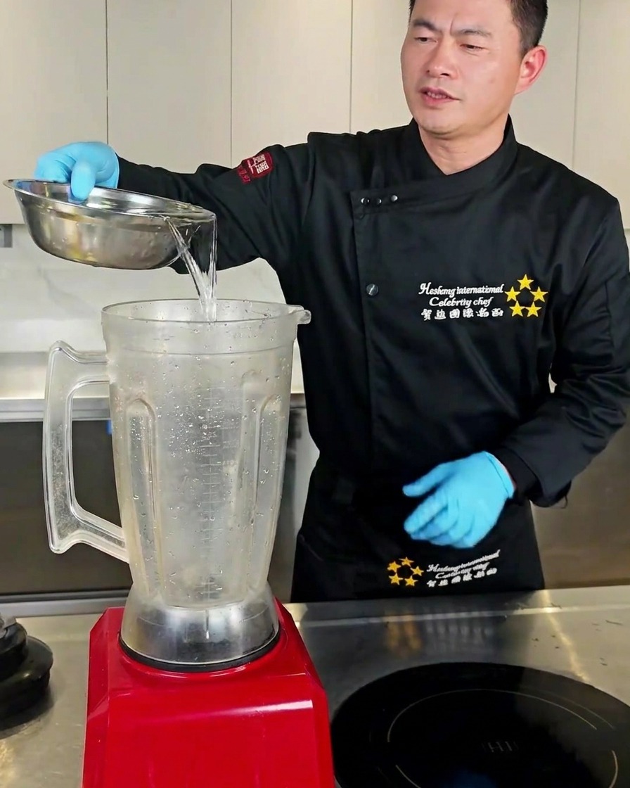 Water and garlic cloves inside a blender jar.