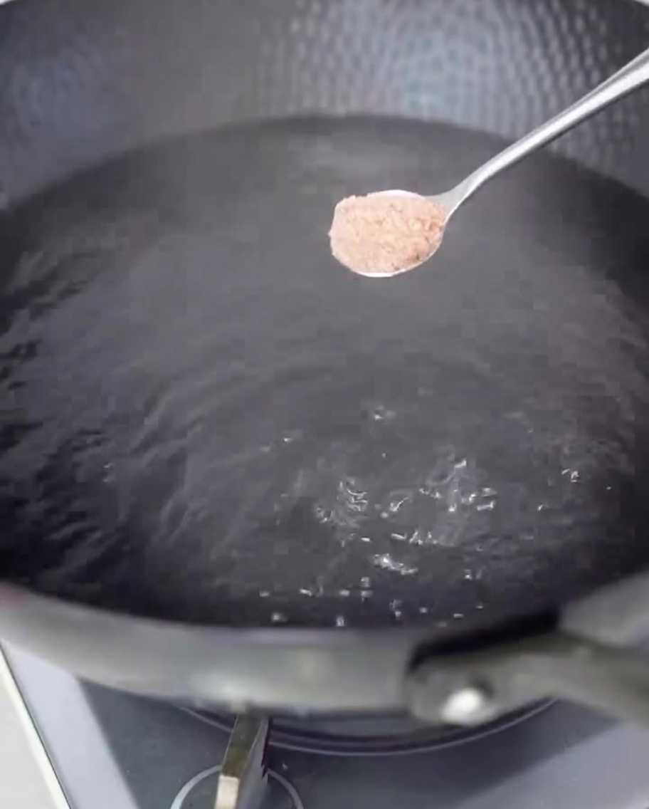 Spaghetti cooking in a large pot of boiling salted water.