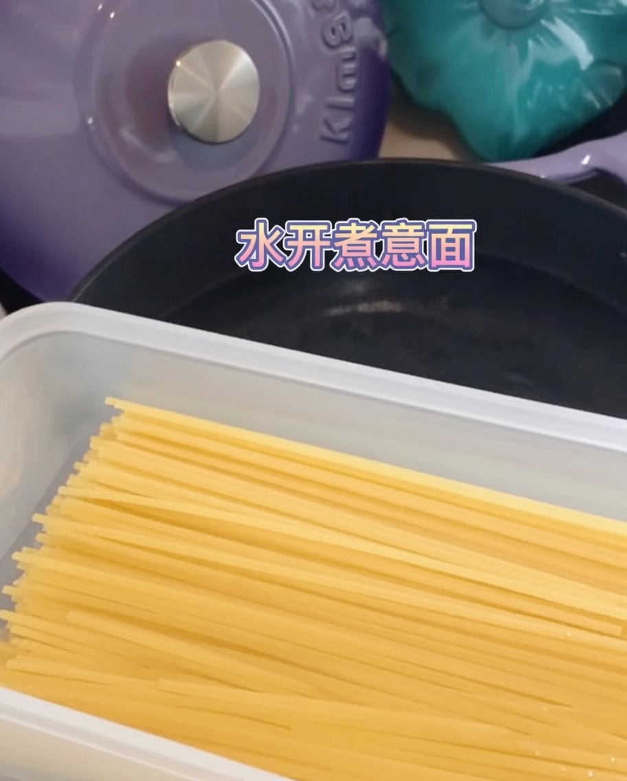 Spaghetti noodles fully submerged and cooking in a pot of boiling water.