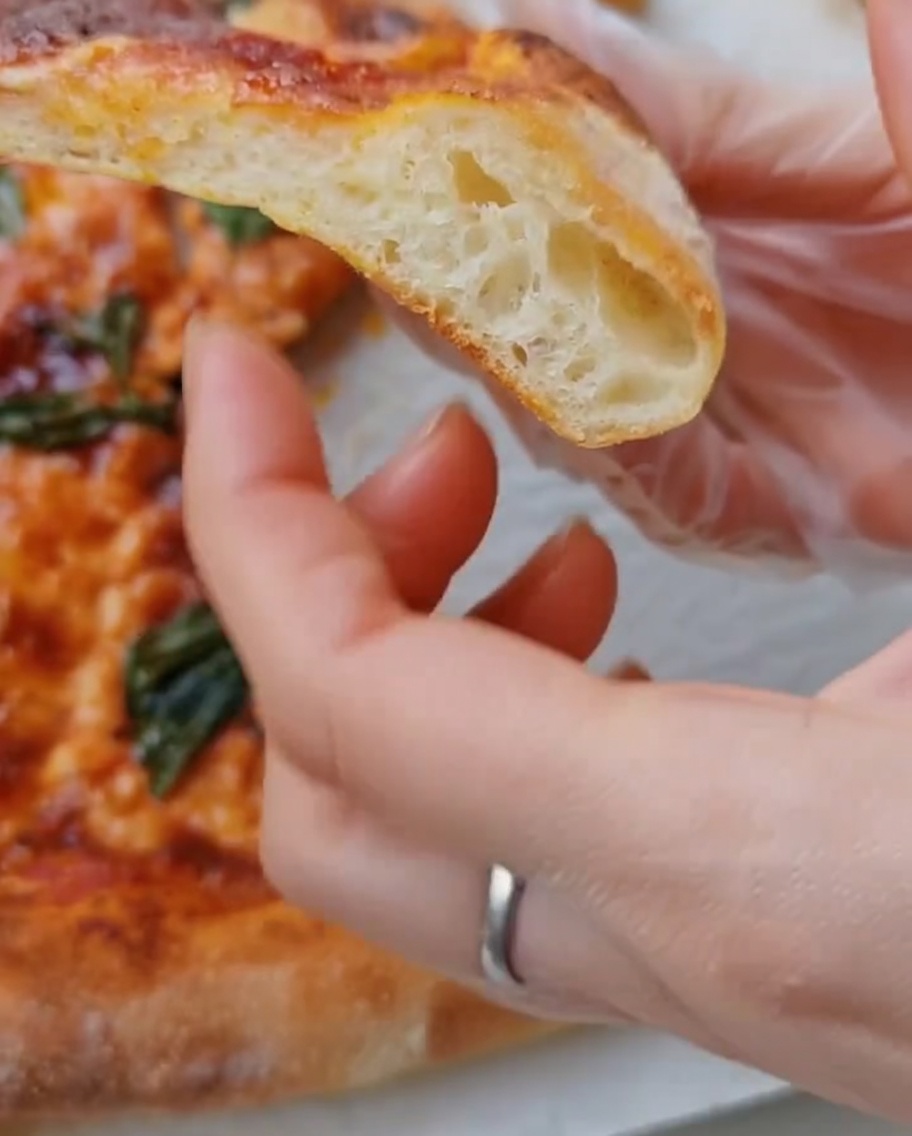 Dough being placed onto a piece of parchment paper on a baking tray.