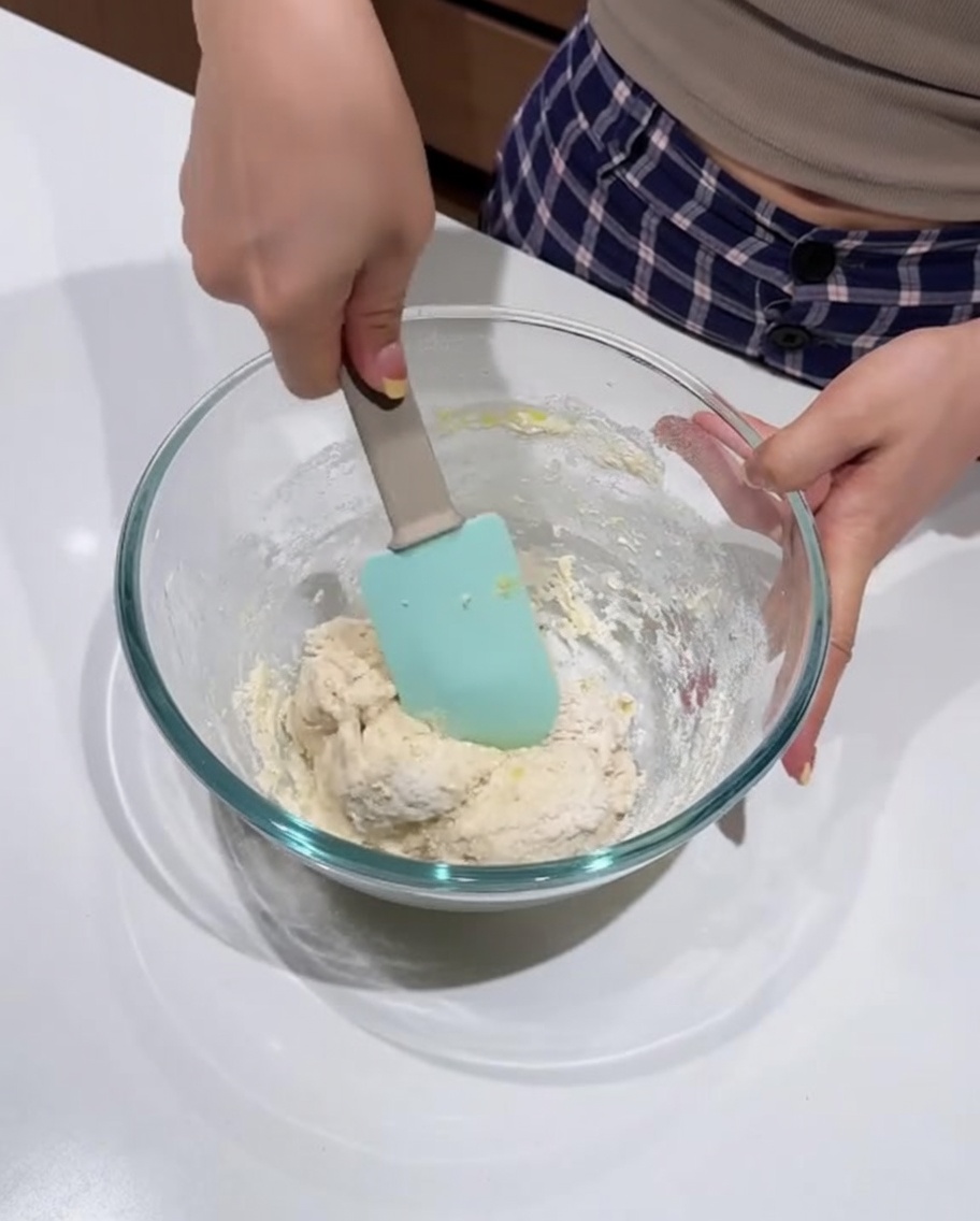 Dough being mixed with a silicone spatula until smooth and uniform.