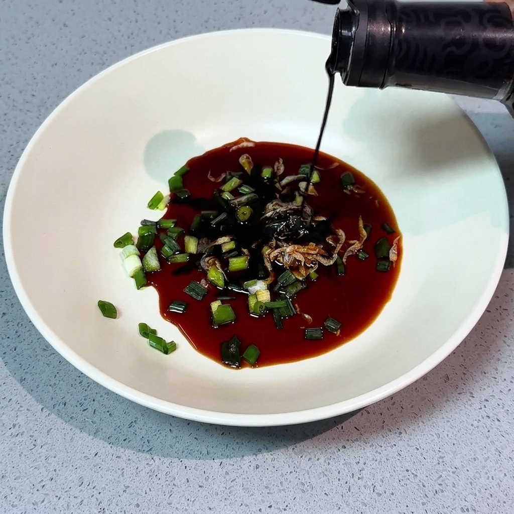 A spoonful of salt being added to a white bowl containing scallions and other seasonings.