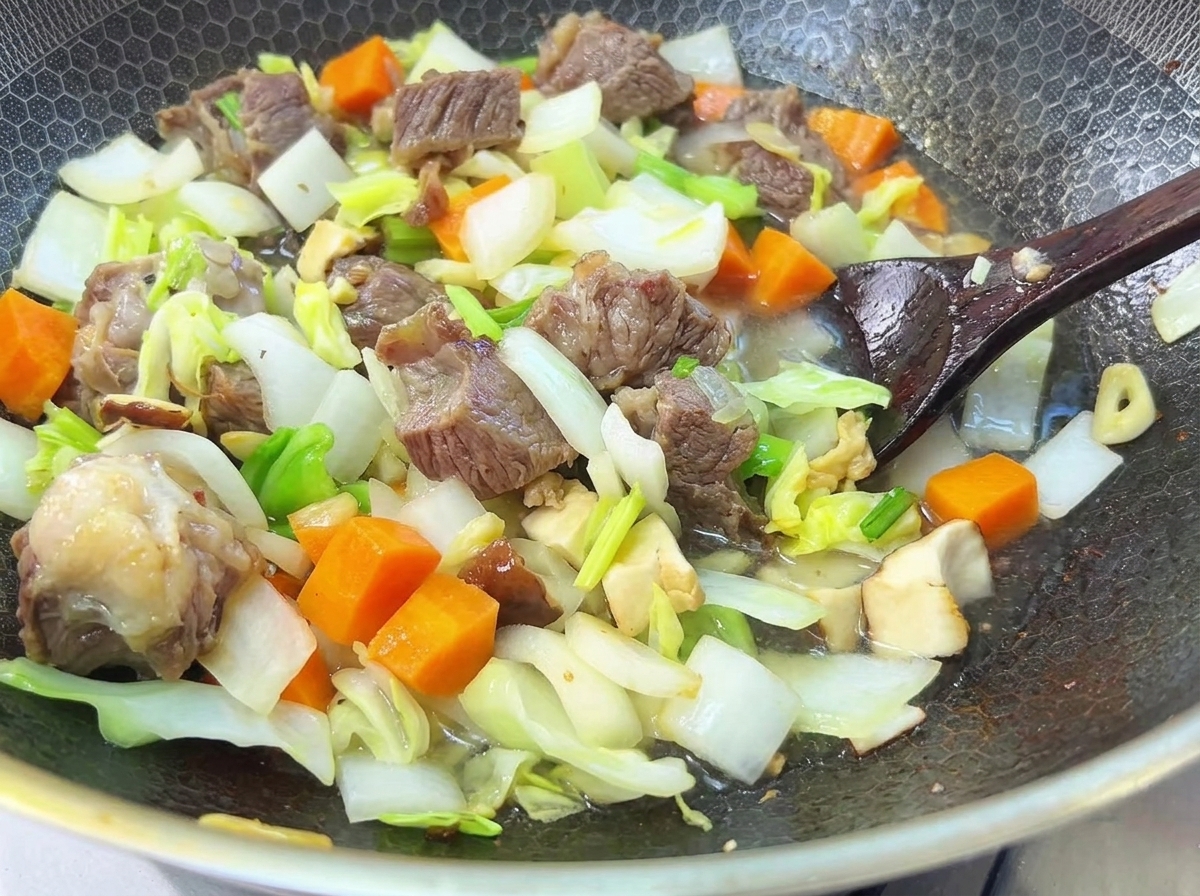 Water being poured over the beef and vegetables in a pan, ready for a long simmer.