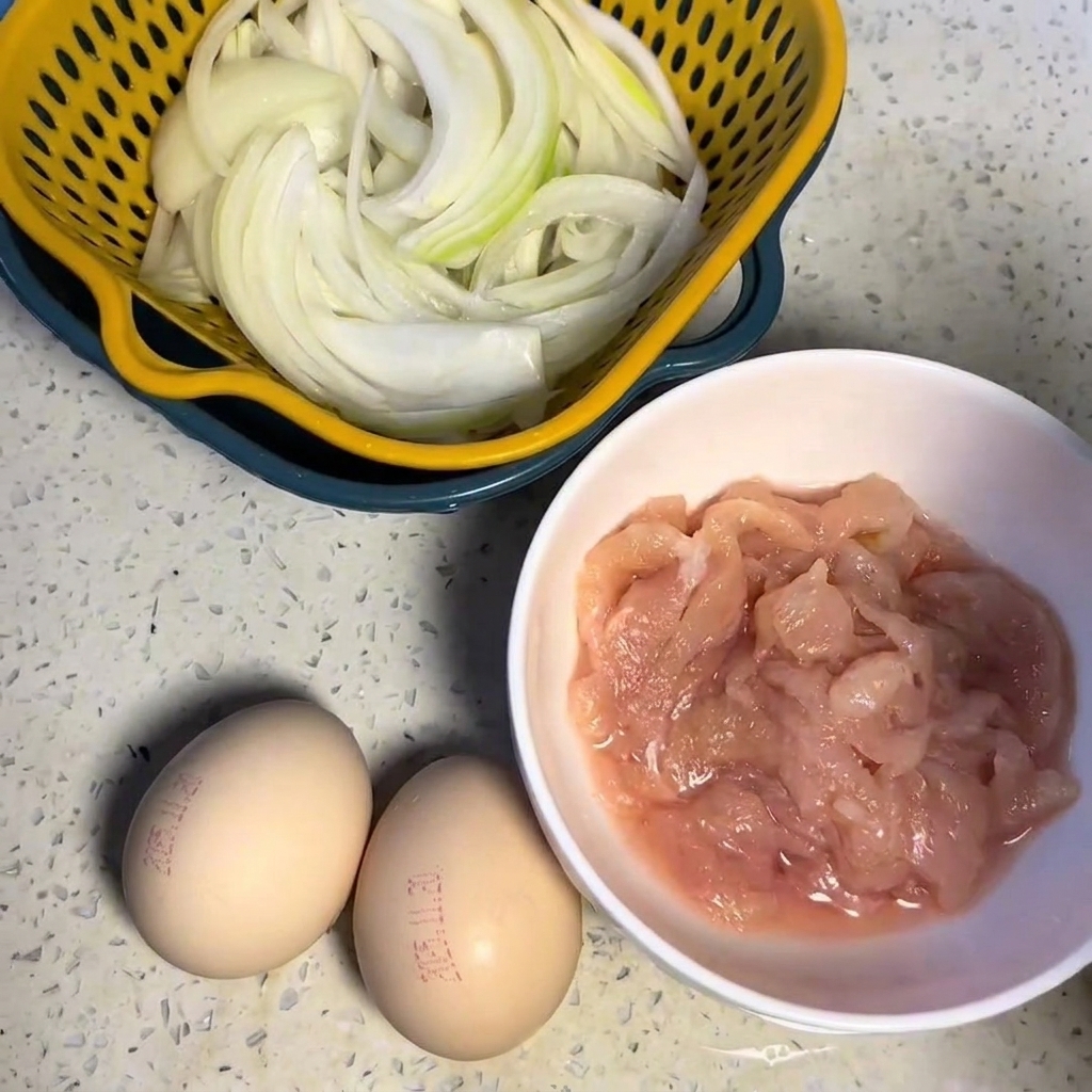 Chicken breast pieces coated in a dark marinade inside a white bowl.