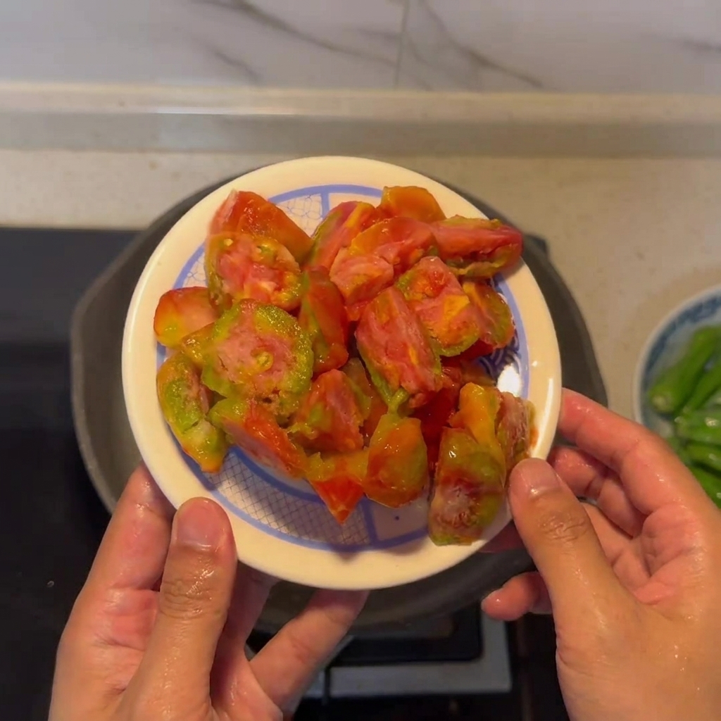 A plate of peeled, chopped tomatoes ready to be cooked.