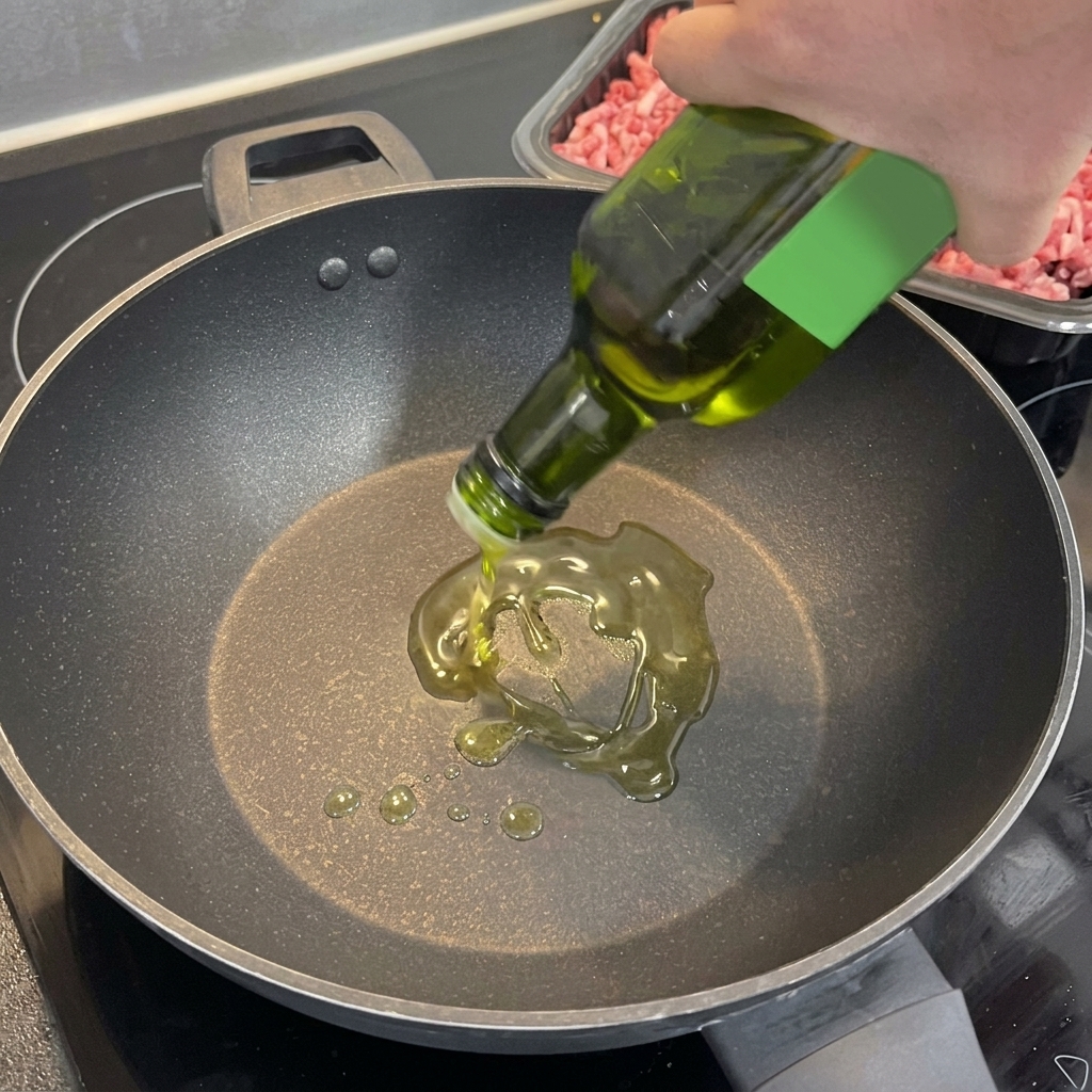Fragrant garlic and chili mixture sizzling in a hot wok with oil.