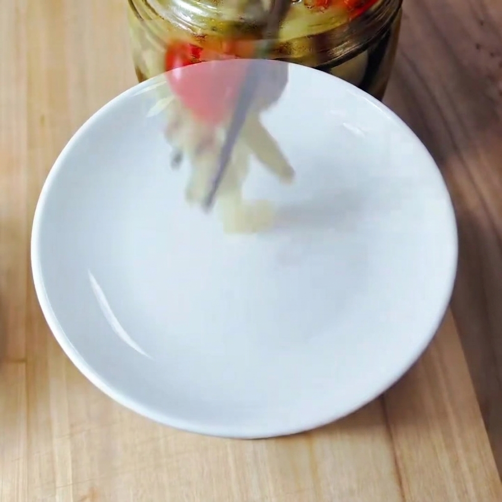 Finely chopped kimchi pieces on a wooden cutting board.