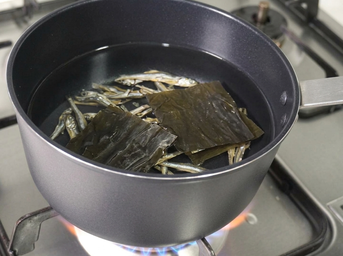 Dried anchovies and a square piece of dried kelp floating in the pot of water.