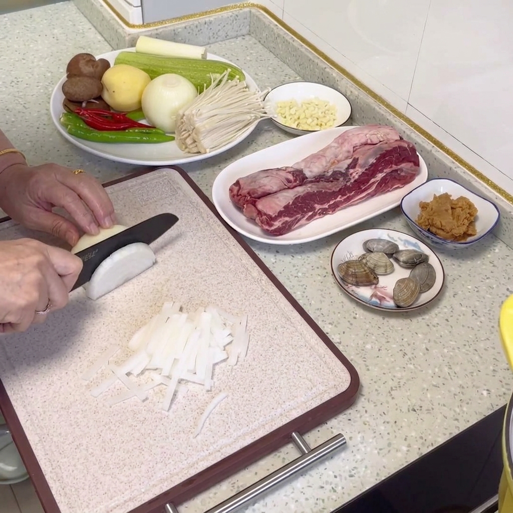 Thinly sliced radish strips arranged neatly on a cutting board.