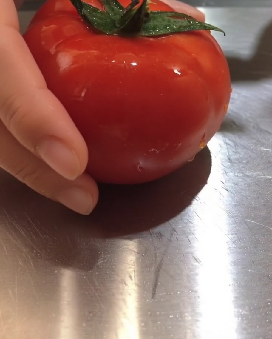 Fresh tomato chunks resting on a cutting board.