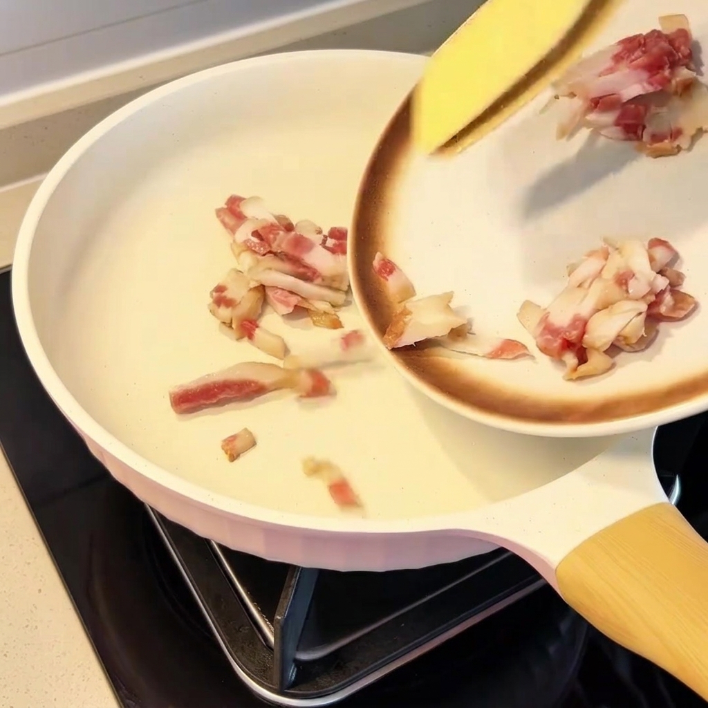 Guanciale pieces evenly distributed in a dry pan.