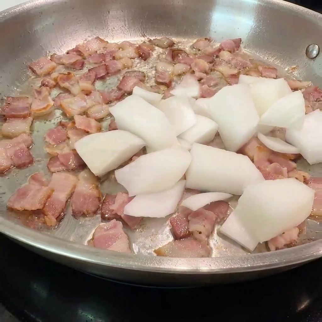 Chopped onions and mushroom slices being added to a pan with crispy, browned bacon.