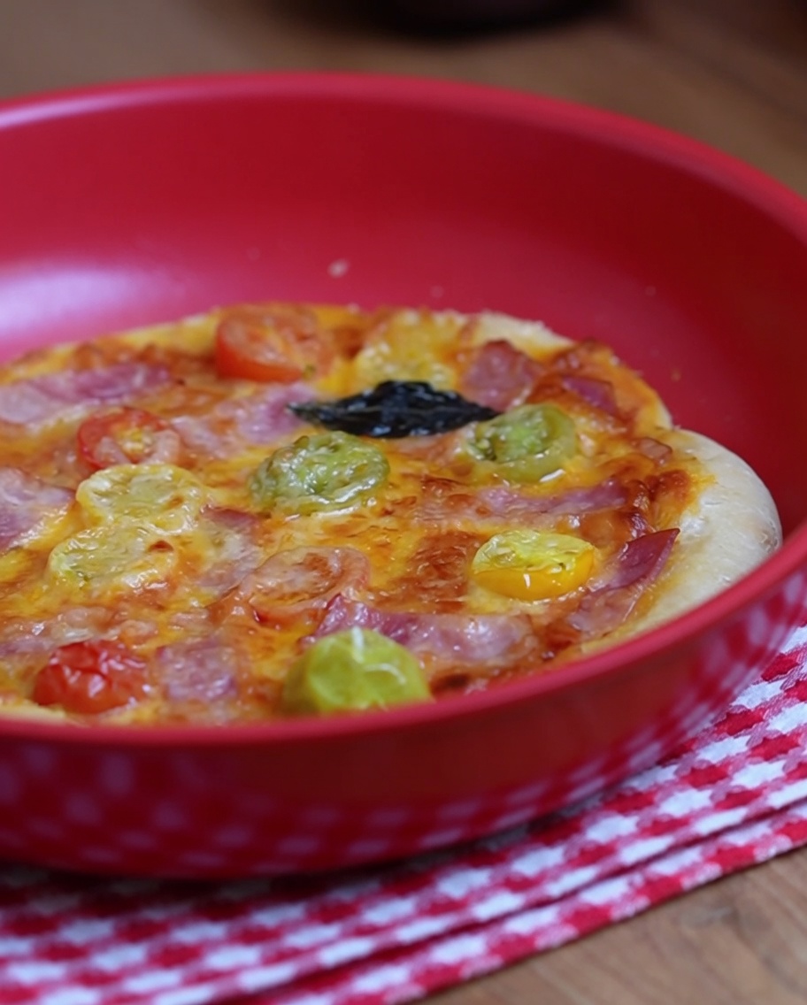 A fork being used to prick small holes all over the center surface of the shaped raw pizza dough.