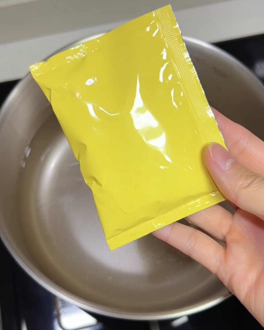 The concentrated tonkotsu soup base being poured into a pot.