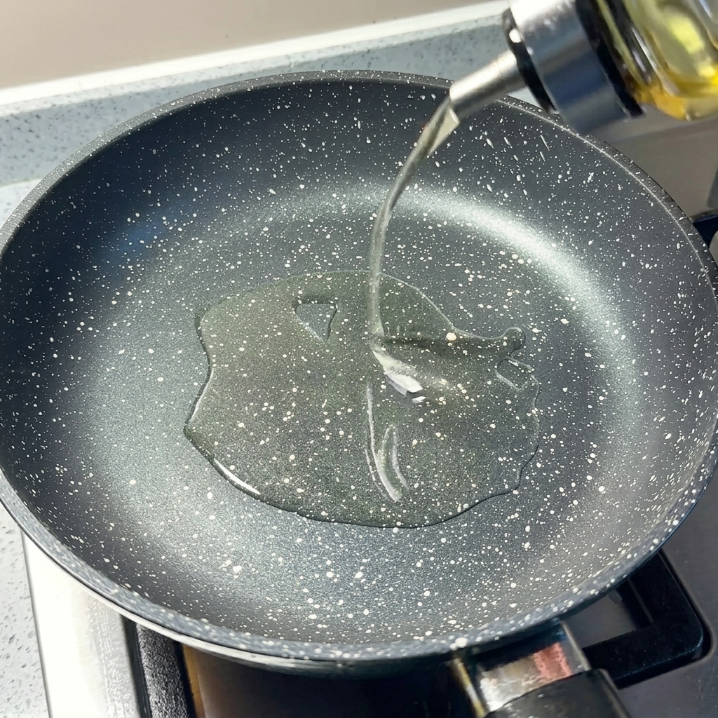 Finely chopped green scallions and minced garlic sizzling in the hot oil in a pan.