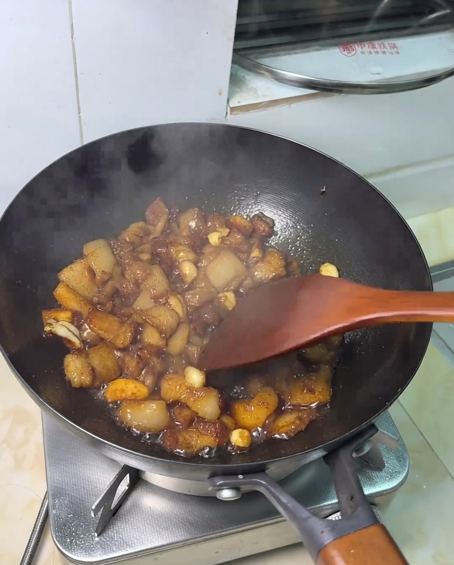 Finished soy sauce stir-fried pork belly, glistening with a savory glaze.