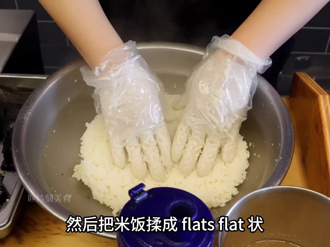 A chefs gloved hands pressing seasoned sticky rice into a neat, flat, round patty shape.
