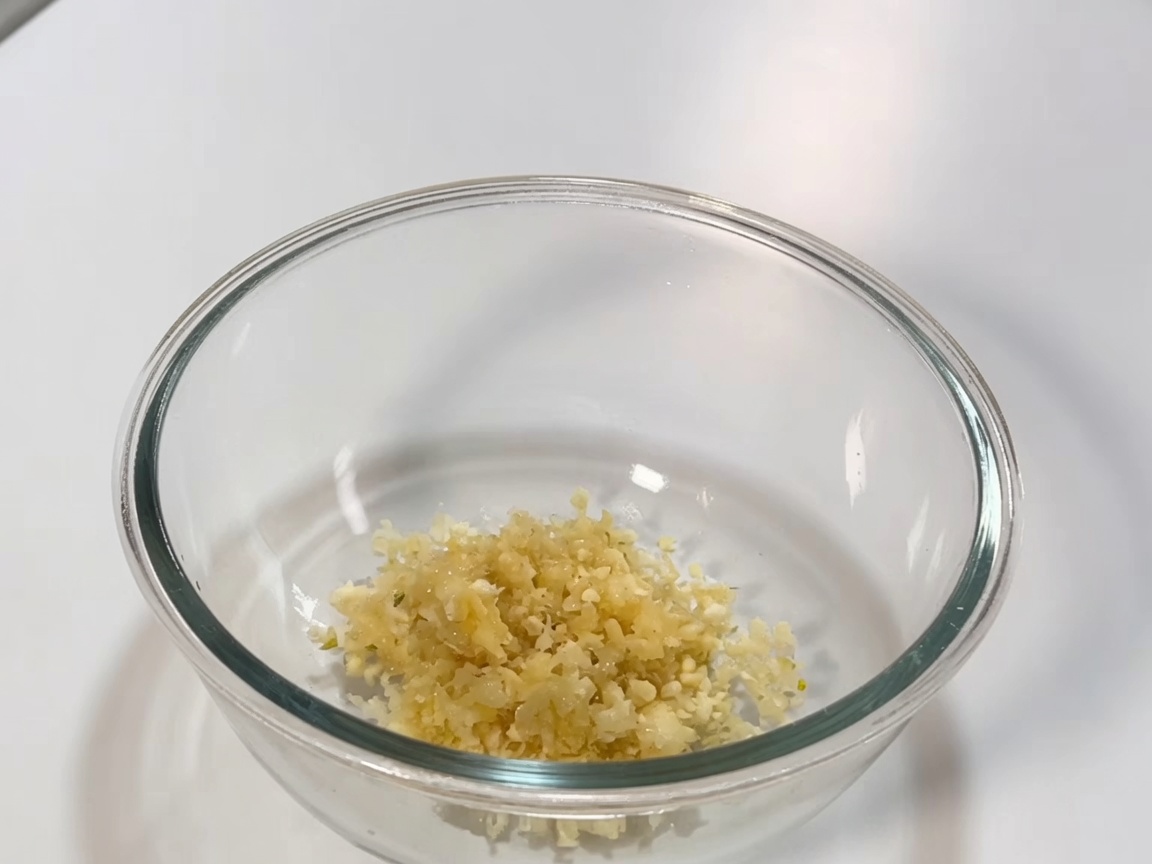 Glass bowl containing the mixture of chili paste, soy sauce, and aromatics for the braising sauce.