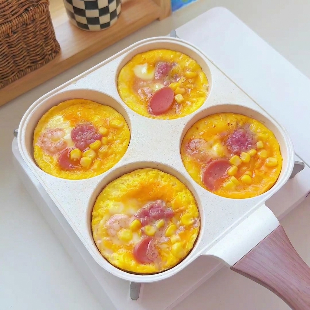 Round cooked egg patties being transferred from the pan to a white serving plate.