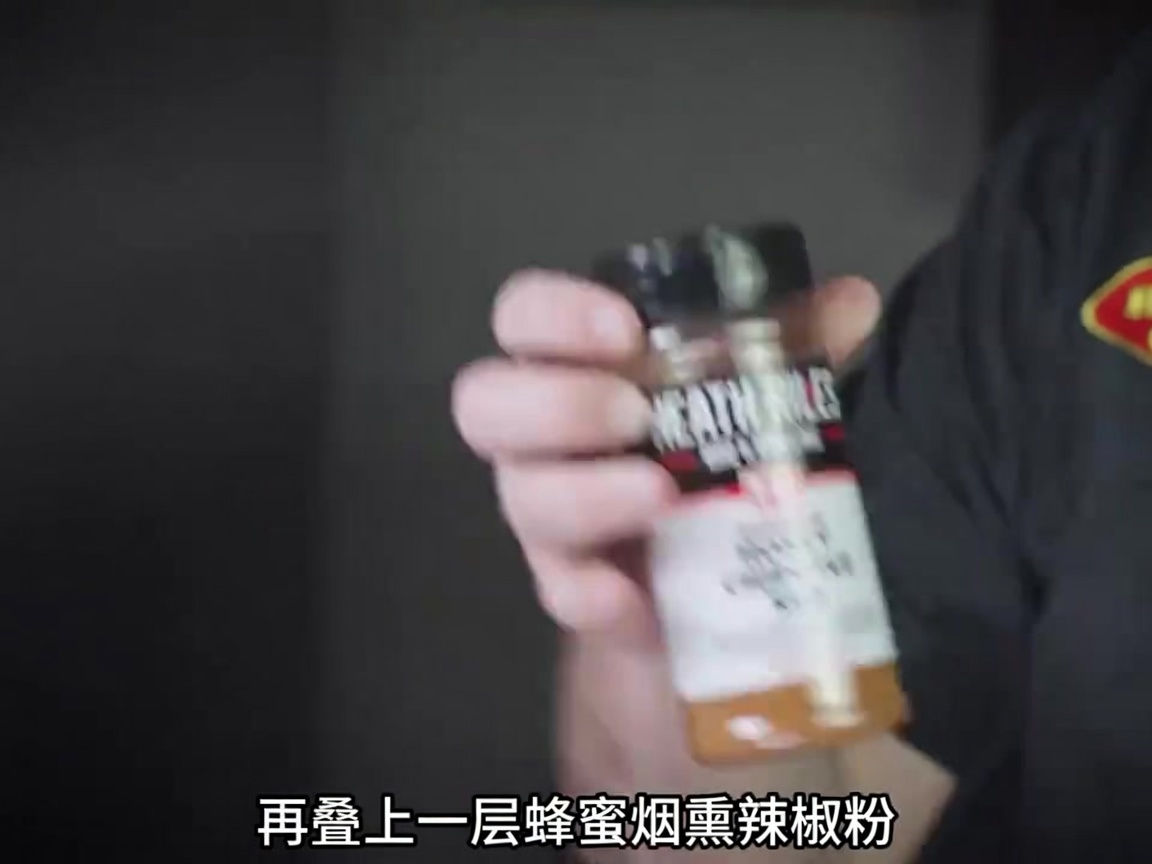 A spice container being used to sprinkle layered seasonings over prepared barbecue ribs.
