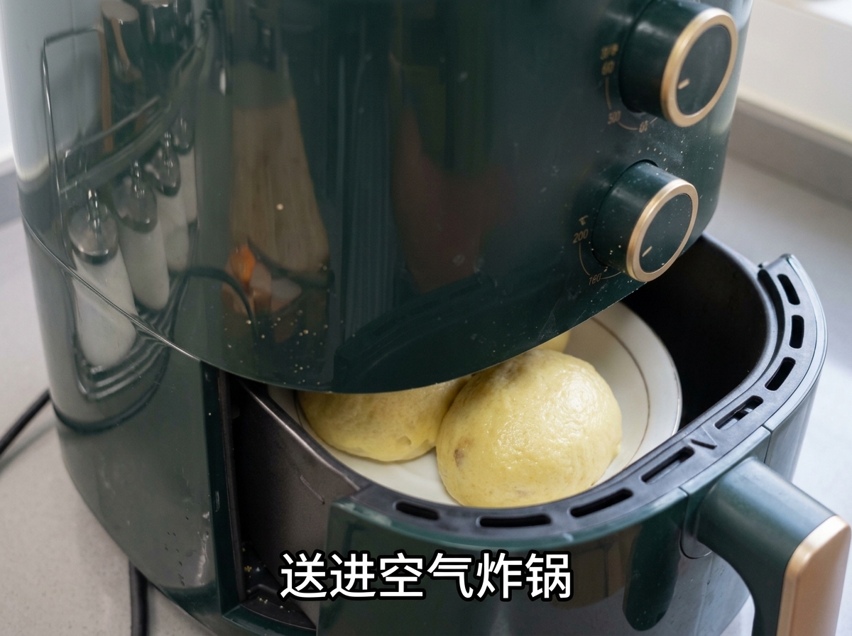 An air fryer basket filled with oiled potatoes being pushed into a green air fryer.
