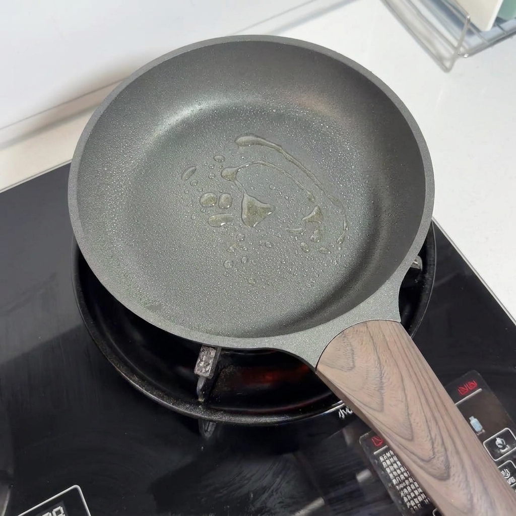A non-stick pan with oil sprayed across the bottom, ready for cooking.