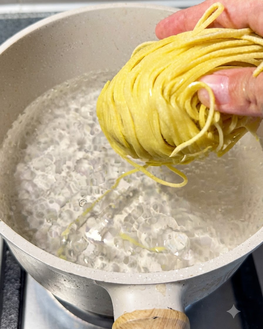 Ramen noodles boiling in a pot of water, being lifted up with chopsticks to check doneness.