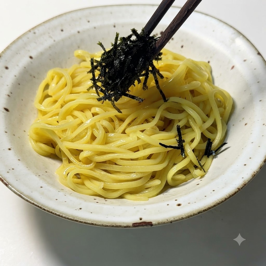 Shredded seaweed being placed on top of ramen noodles using chopsticks.
