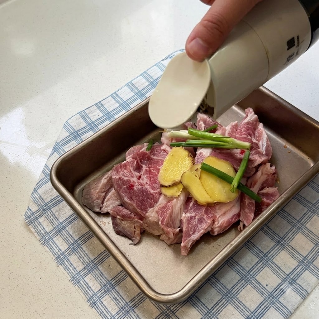 Pork slices arranged in a tray with ginger slices and scallions while soy sauce is being poured over them.