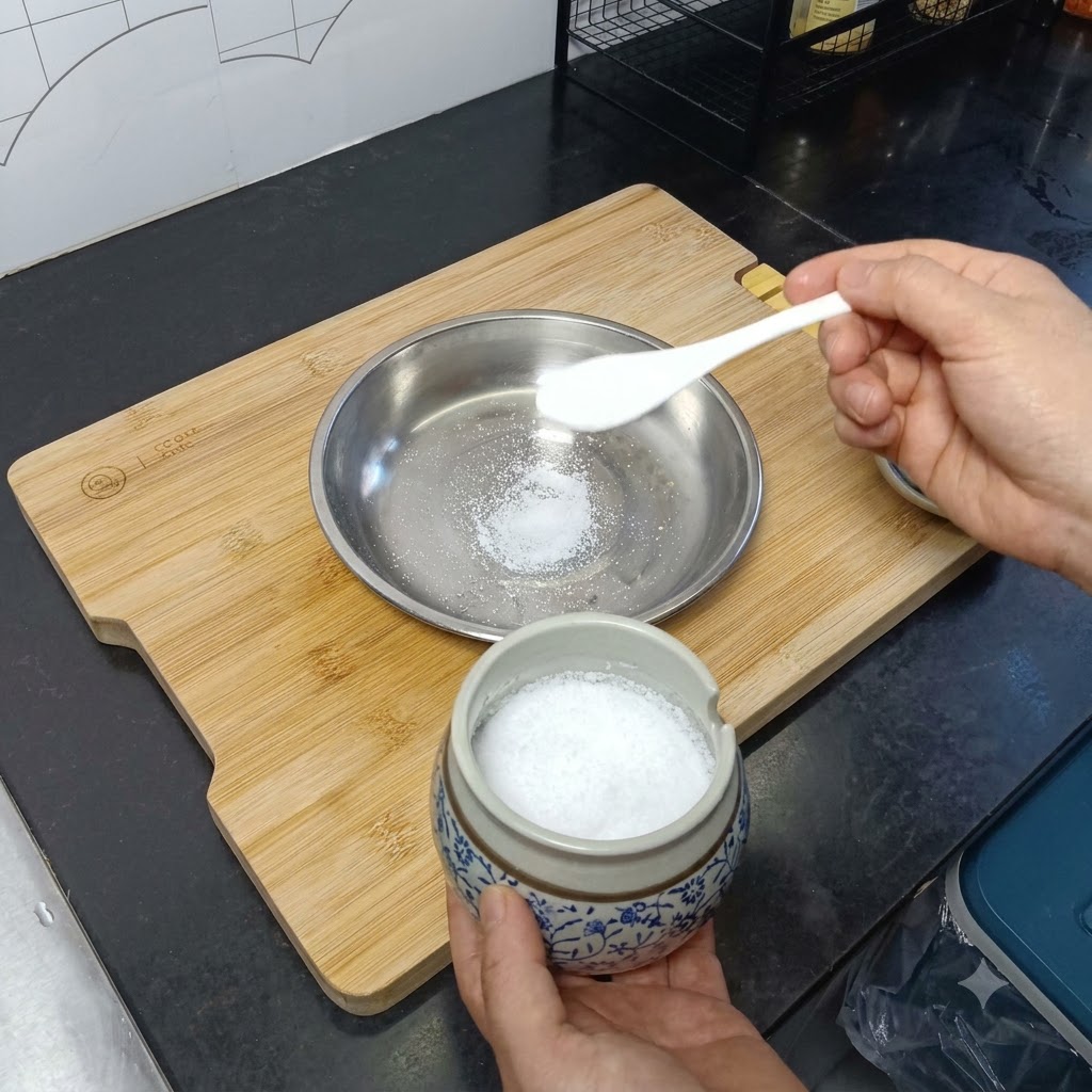 Salt and oil poured into a stainless steel plate.