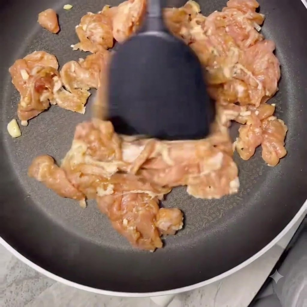 Pork slices cooking in a dry frying pan until browned and dry.