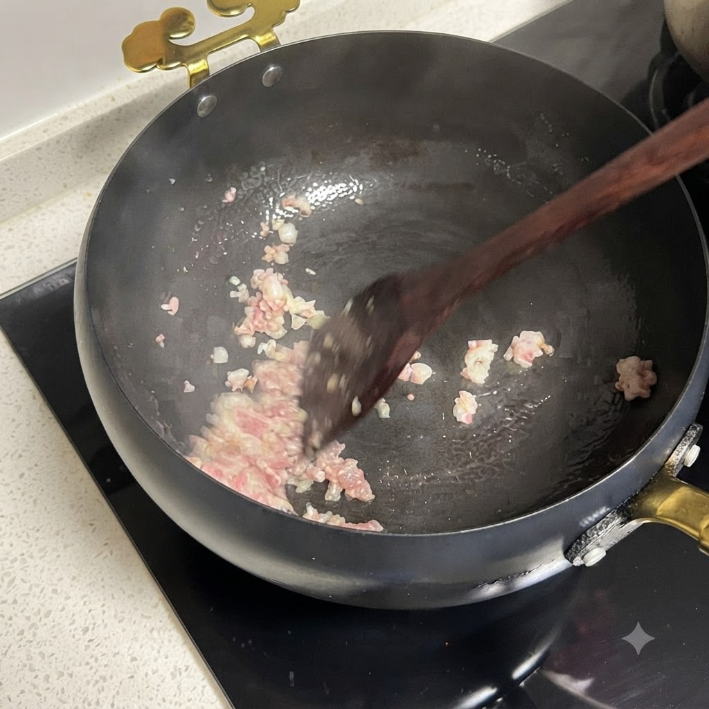 Diced red onions and chopped tomatoes cooking together in a pan.