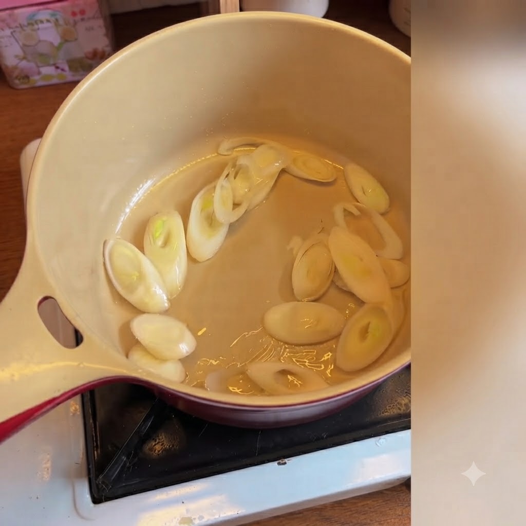 Korean kimchi being added and mixed with sliced scallions inside a ceramic pot.