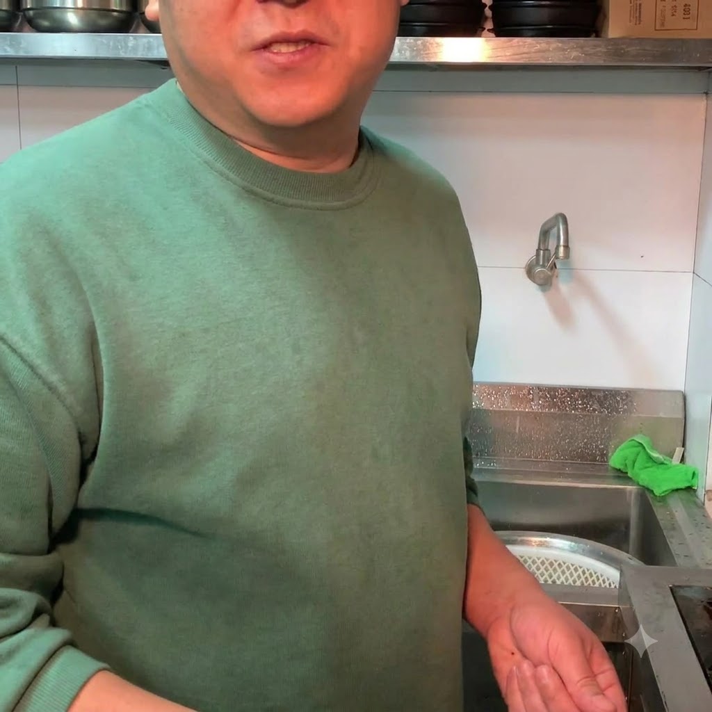 Chopped green onions being sprinkled over the completed soybean paste stew.