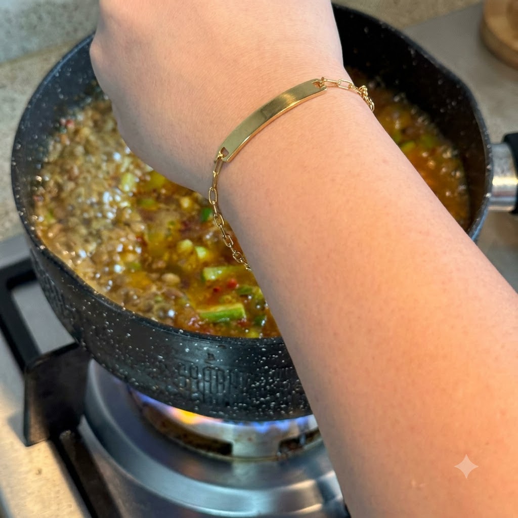 An egg being cracked directly into the bubbling pot of Korean stew.
