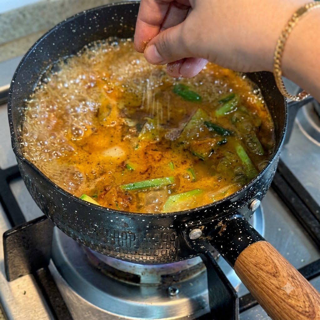 A glass lid being placed on top of the boiling pot of stew.