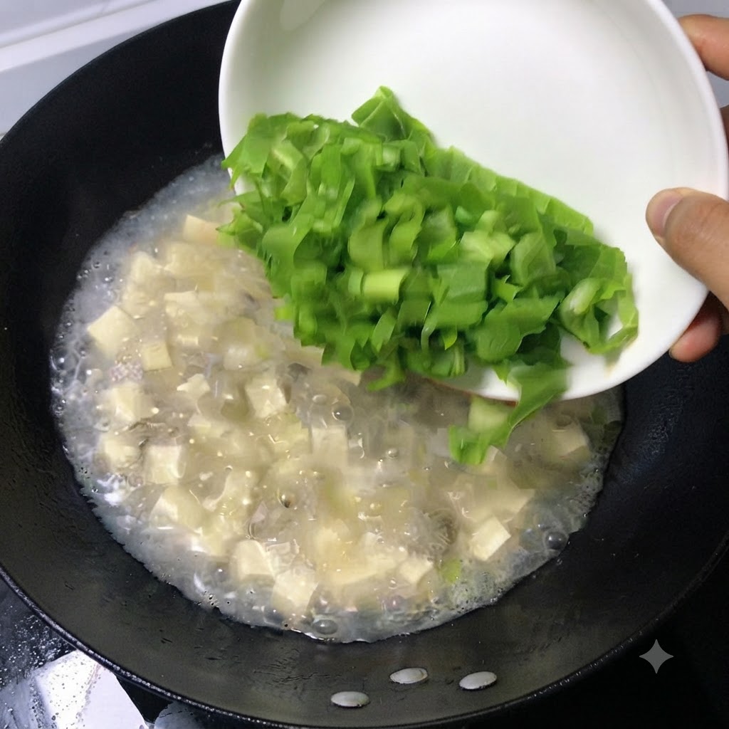 Fresh green chopped leaves sliding off a white dish into a bubbling pot of soup.