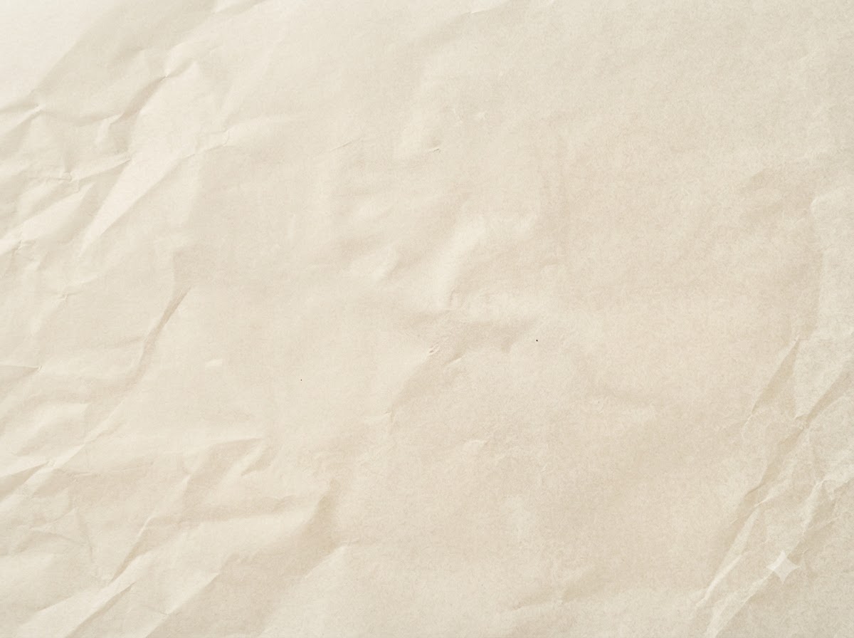 Shaped raw meat patties resting on a sheet of parchment paper.