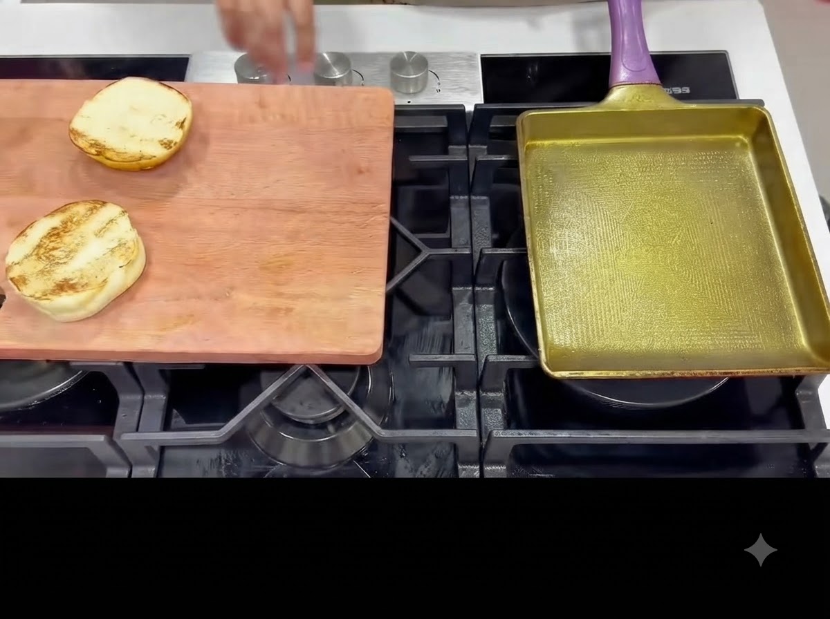 Tongs flipping chicken thighs in a frying pan to sear the other side.