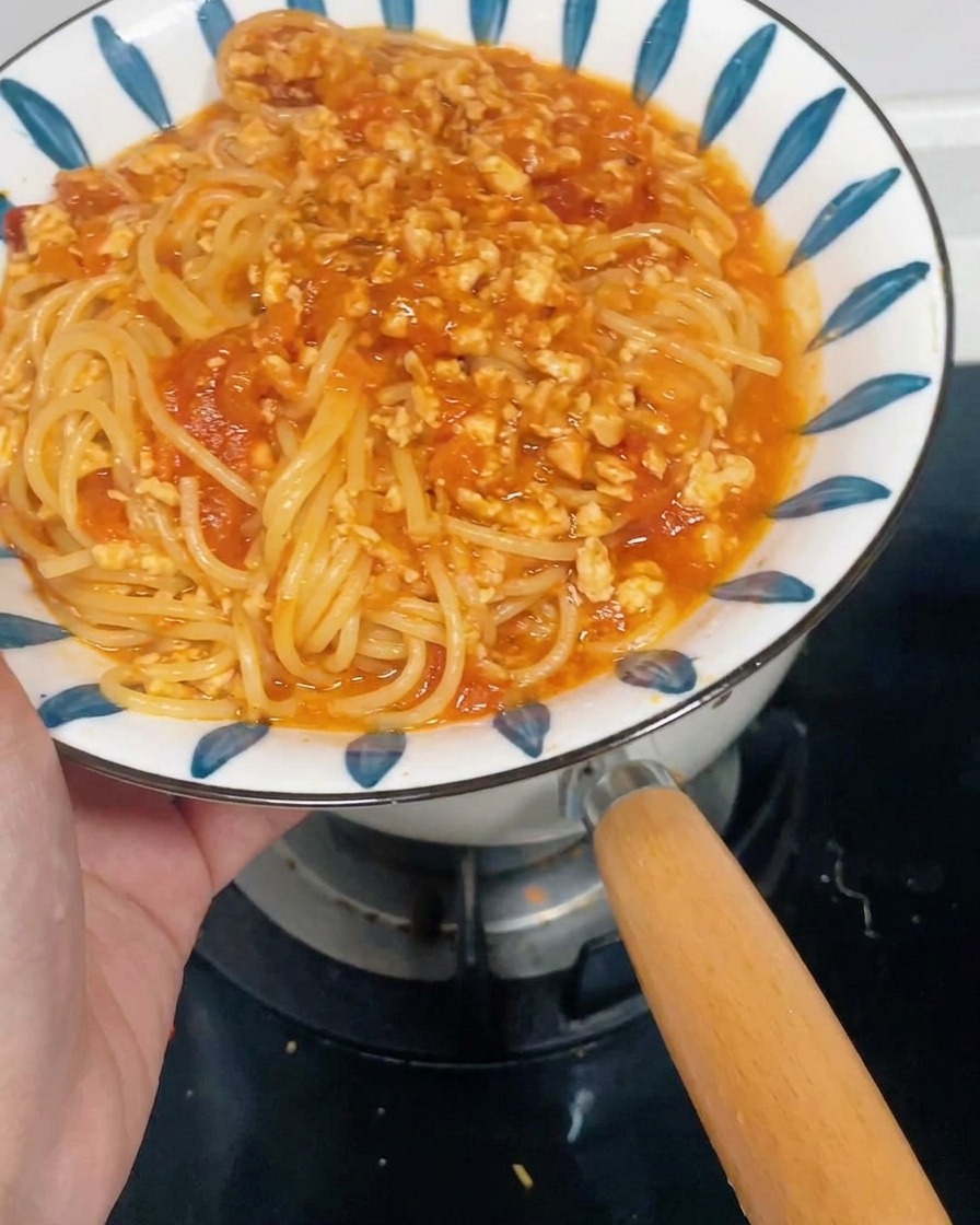 Chopped carrots and red onions inside a clean food processor bowl.