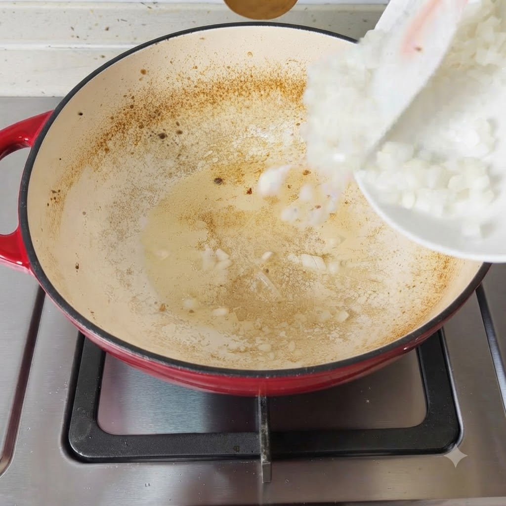 Chopped onions hitting the hot, seasoned pan surface.