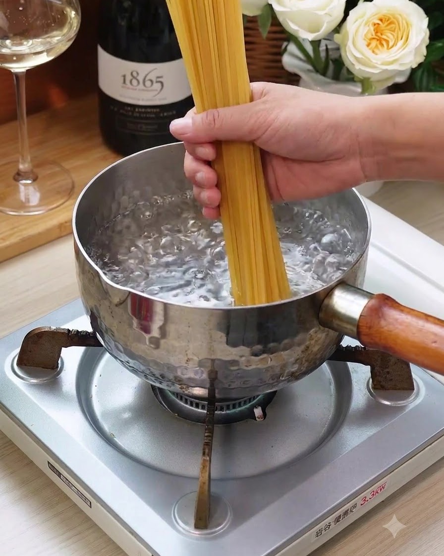 A bunch of dry spaghetti noodles being lowered into a pot of boiling water on a stove.