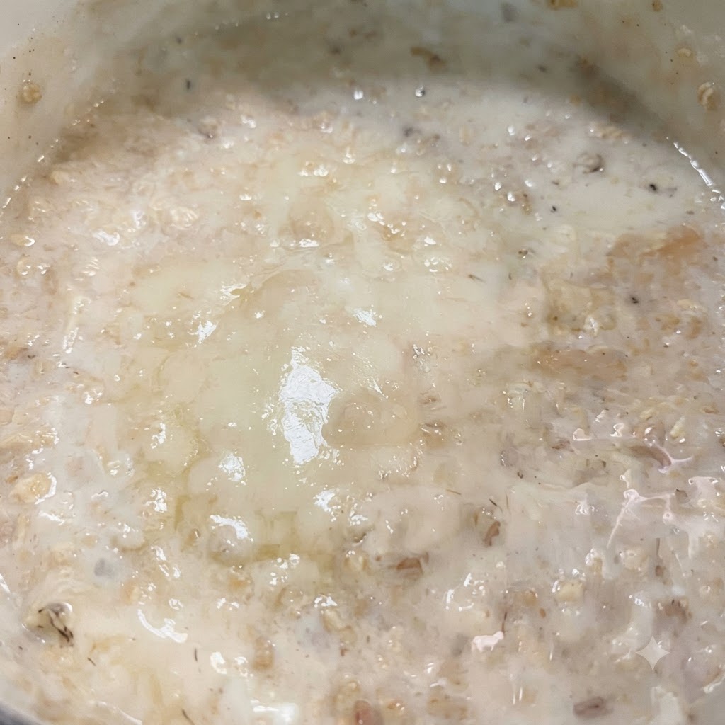 Milk and a slice of low-fat cheese melting together in the pan to form a creamy sauce.