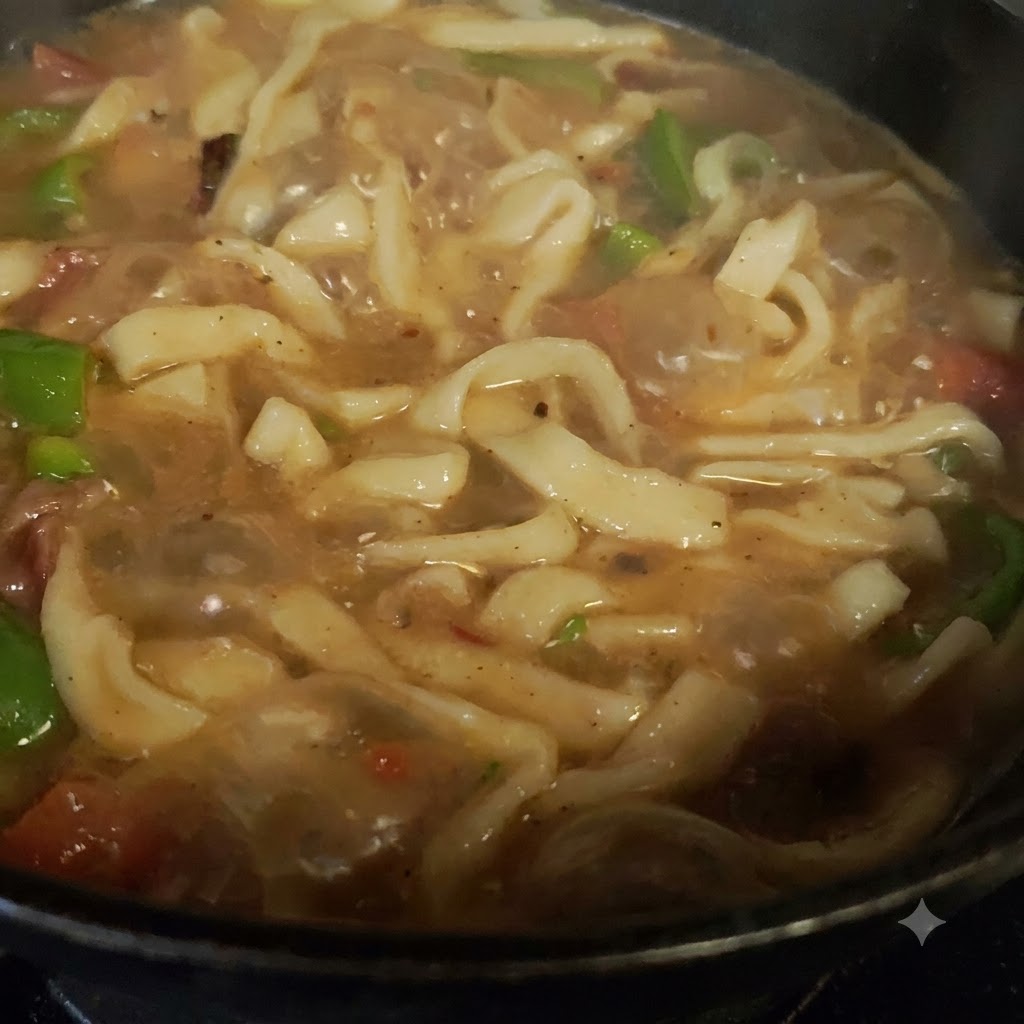 Fresh green peppers and tomatoes mixed with meat in the cooking pot.