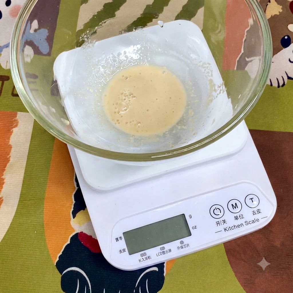 Ingredients such as wheat flour, salt, and olive oil measured inside a glass bowl resting on a digital kitchen scale.