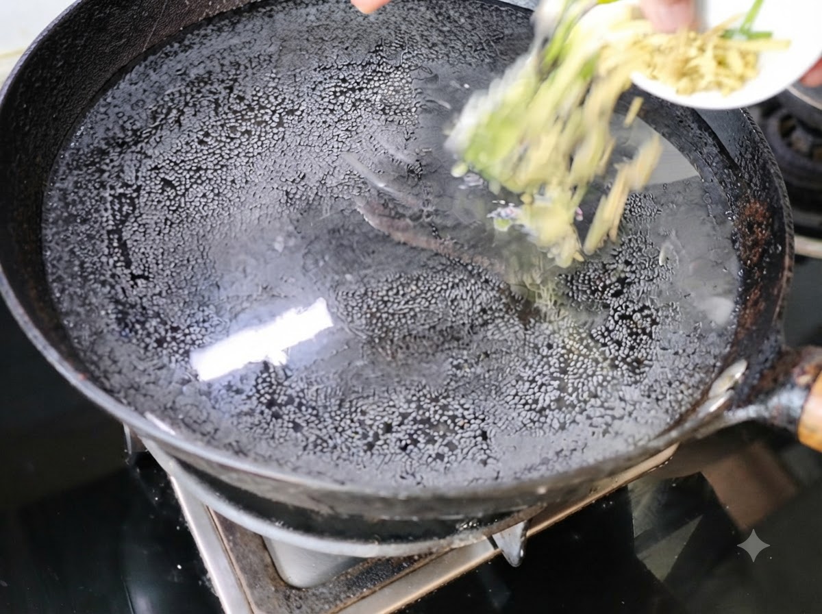 Chopped scallions and ginger being added into a wok of water on the stove.