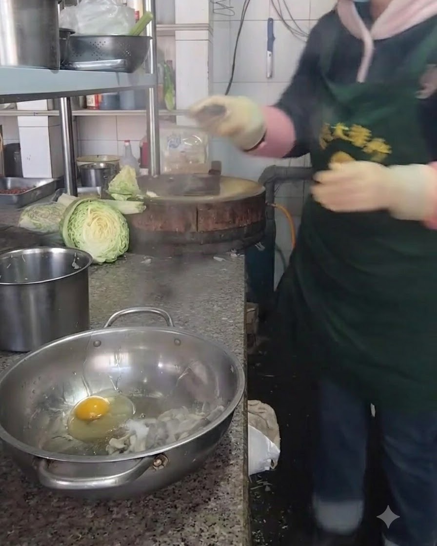 Bowl containing oyster mushrooms and a cracked egg being seasoned with salt and spices.