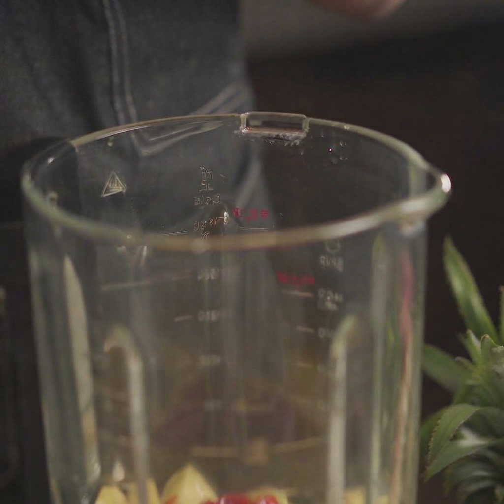 Apple cider vinegar and soy sauce being poured into the glass blender container.