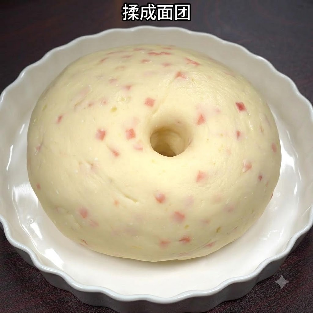 Smooth potato and ham dough formed into a ball inside a white ceramic dish.