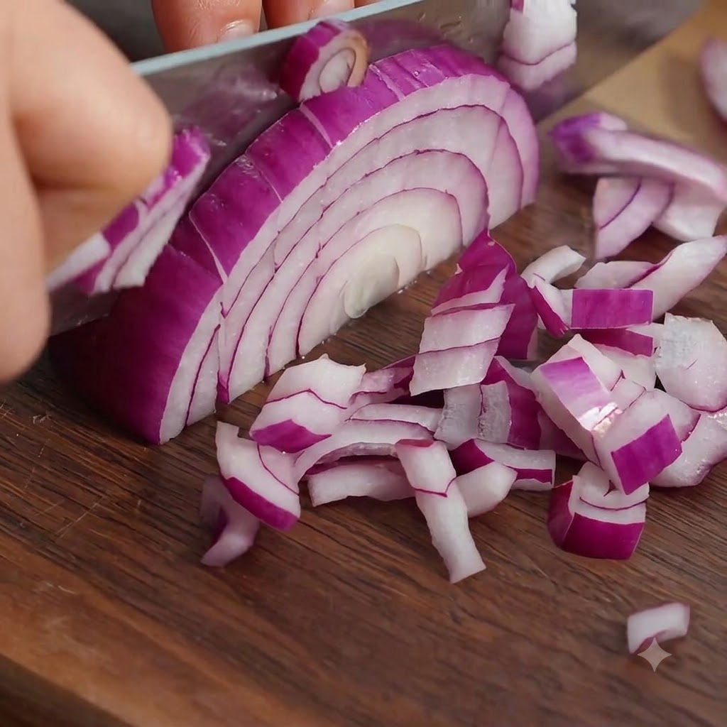 Bacon strips being sliced into small uniform pieces on a wooden board.